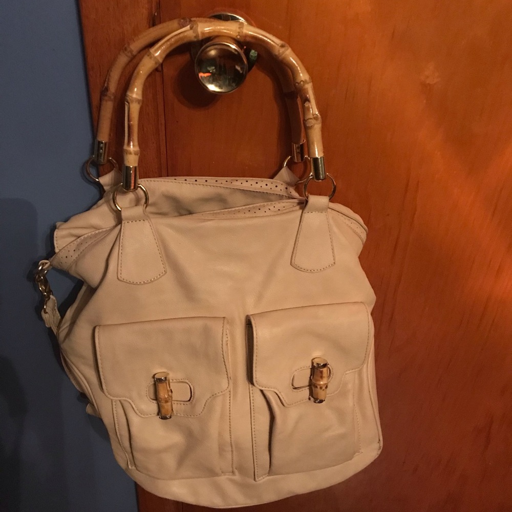 Light tan leather bag with wooden handles